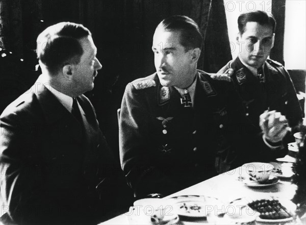 Adolf Hitler in conversation with German air force fighter ace Adolf Galland, 1941. Artist: Unknown