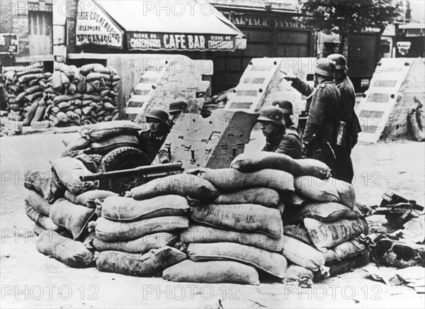 German soldiers with captured French barricade, near Paris, June 1940. Artist: Unknown