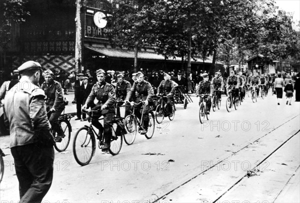 German soldier cycling through the streets of Paris, June 1940. Artist: Unknown