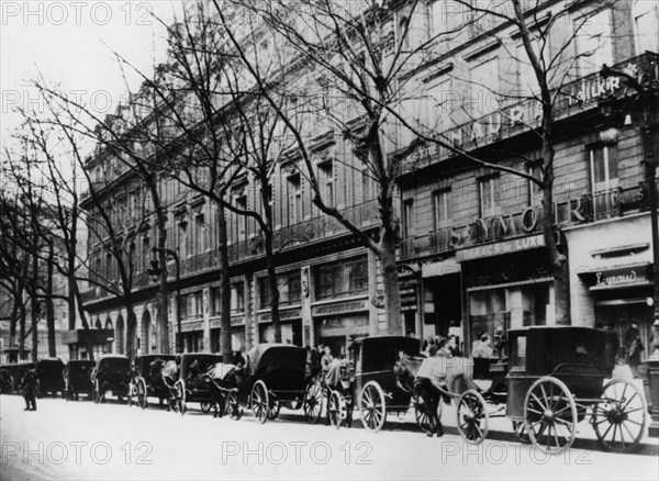 Horse-drawn cabs on a street during the German occupation, Paris, 1944. Artist: Unknown