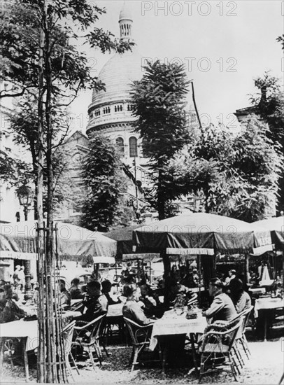 German soldiers relaxing outside a restaurant in Montmartre, Paris, June 1941. Artist: Unknown