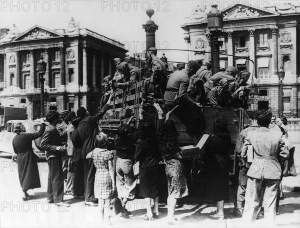 French street sellers offering souvenirs to a truckload of German soldiers, Paris, 27 July 1940. Artist: Unknown