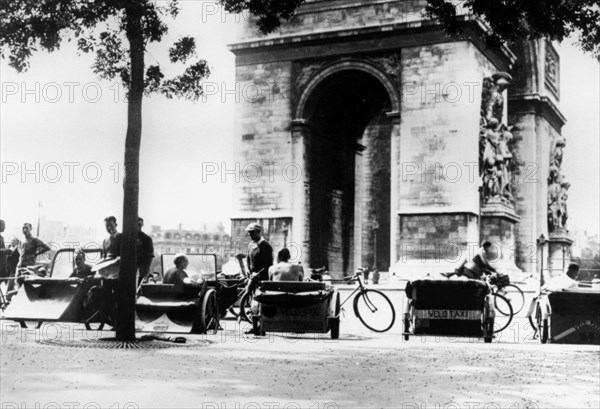 Bicycle taxis in the Place d'Etoile by the Arc de Triomphe, German-occupied Paris, August 1943. Artist: Unknown