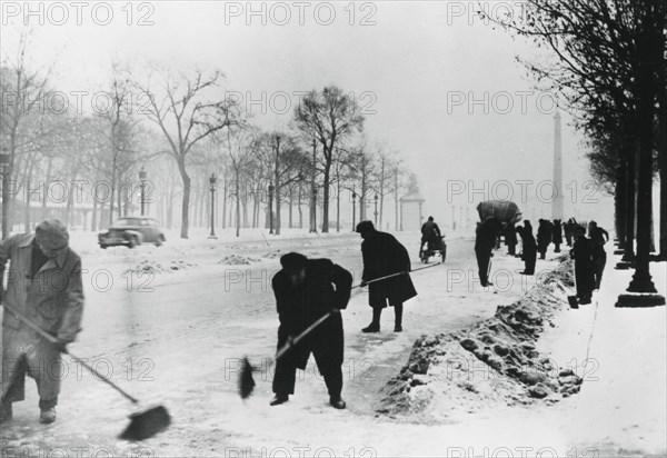 Clearing snow on the Champs Elysees, German-occupied Paris, winter, 1941. Artist: Unknown