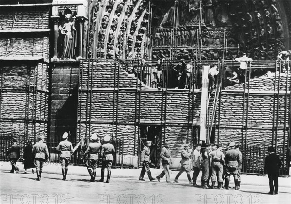 Clearing of sandbag protection from the facade of Notre Dame, German-occupied Paris, 1940. Artist: Unknown