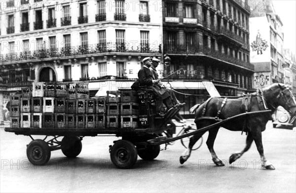 Horse-drawn cart carrying crates of drink, German-occupied Paris, July 1940. Artist: Unknown