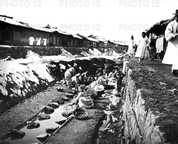 Washing clothes outdoors, Korea, 1900. Artist: Unknown