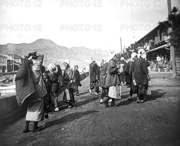 Woman carrying loads of coal, Nagasaki, Japan, c1900. Artist: Unknown