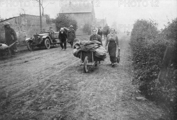 A British soldier helping a woman return to her village, France, 1918. Artist: Unknown