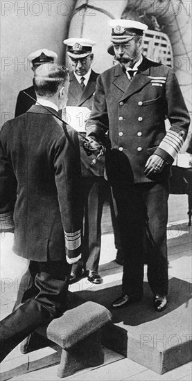 King George V knights Vice-Admiral Pakenham aboard HMS Princess Royal, c1930s. Artist: Unknown