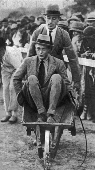 Louis Mountbatten wheels his cousin, the Prince of Wales, at a gymkhana in Malta, 1936. Artist: Unknown