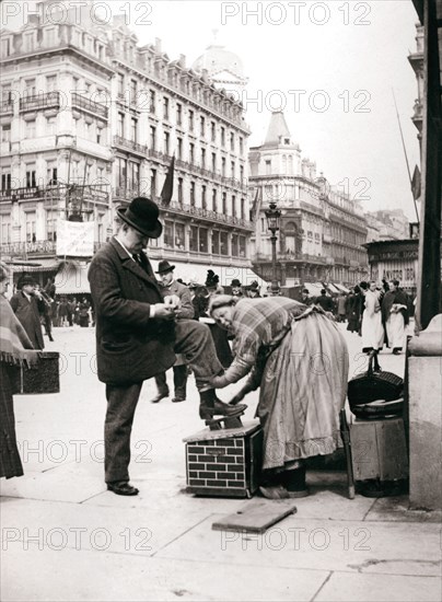 Woman polishing shoes, Brussels, 1898.Artist: James Batkin