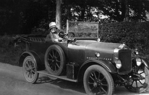 Woman driving a car, 1930. Artist: Unknown