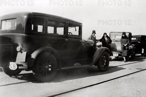 Women and parked cars, 1930. Artist: Unknown