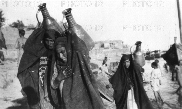 Female water carriers, Amarah, Iraq, 1917-1919. Artist: Unknown