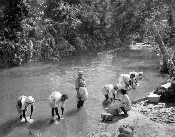 Women washing clothes in the river, Port Antonio, Jamaica, c1905. Artist: Adolphe Duperly & Son