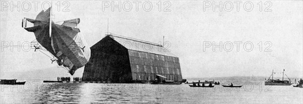 A Zeppelin entering its floating shed, c 1900, (c1920). Artist: Unknown