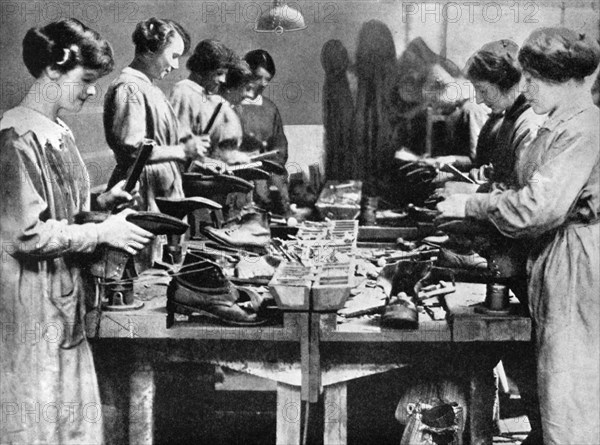Women cobblers repairing footwear for the war effort, 1914-1918 (1936). Artist: Unknown