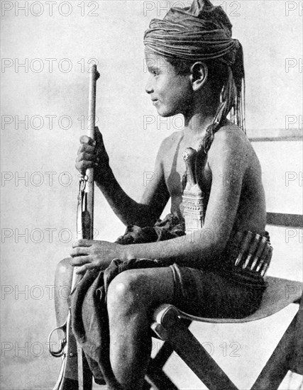 Boy with a gun, Aden Protectorate, Arabia, 1936. Artist: Fox