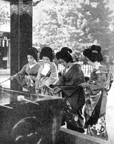 Japanese women washing their hands prior to entering a temple, 1936.Artist: Sport & General