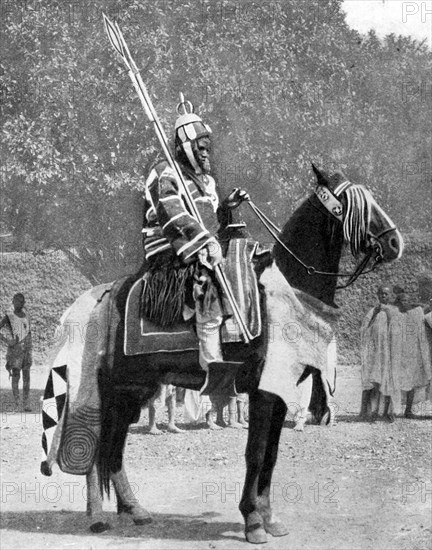 Royal bodyguard in ancient armour, northern Nigeria, 1936.Artist: Wide World Photos