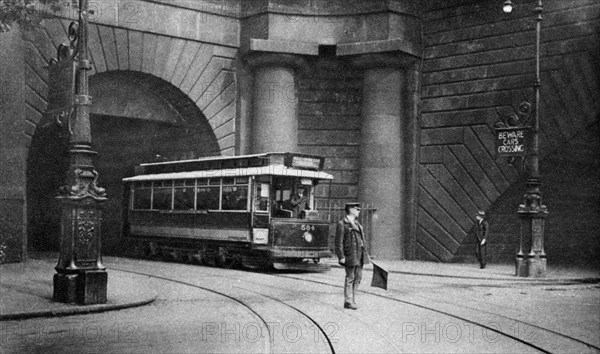 A tram running beneath Kingsway, Aldwych and Somerset House, London, 1926-1927. Artist: Unknown