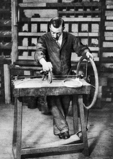 Wire being wound into springs for spring-locks, London, 1926-1927. Artist: Unknown