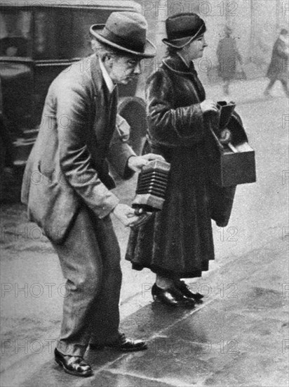 Kerb-side concertina-player, Holborn, London, 1926-1927. Artist: Unknown