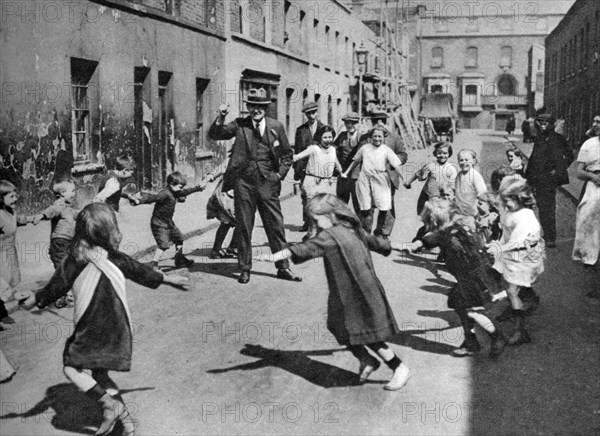 Children dancing in the street, London, 1926-1927. Artist: Unknown