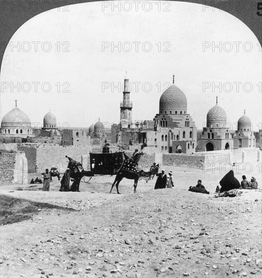 'A 'Ship of the Desert' passing tombs of by-gone Moslem rulers, Cairo, Egypt', 1905.Artist: Underwood & Underwood