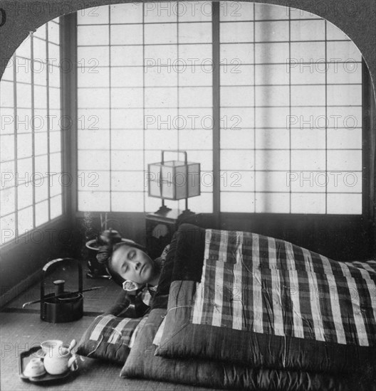 A geisha sleeping in a tea house, Hikone, Japan, 1904.Artist: Underwood & Underwood