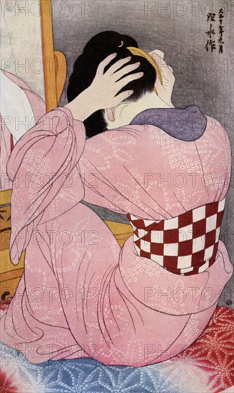 A Japanese woman dressing her hair, 1920s (1930).Artist: Hashiguchi Goyo