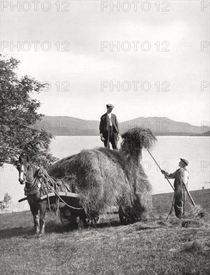 Loading hay onto a wagon on the shores of Loch Lomond, Scotland, 1924-1926.Artist: Donald McLeish