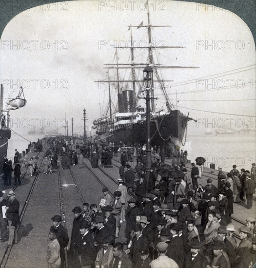 Greetings for newcomers on the pier alongside the Pacific Mail SS 'China, at Yokohama, Japan, 1904.Artist: Underwood & Underwood