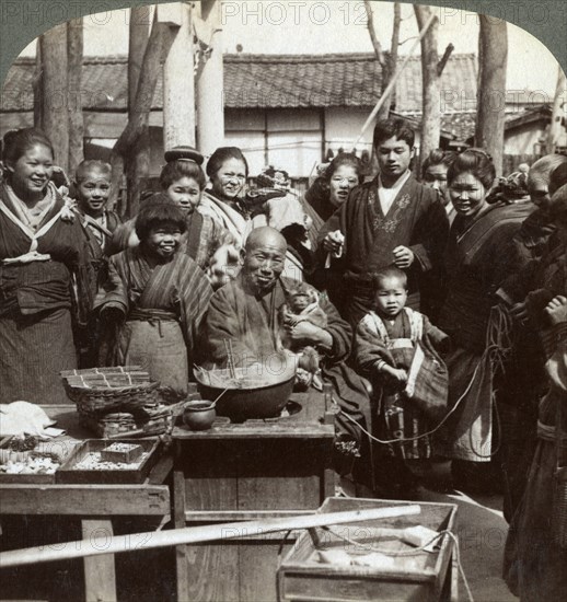 A street performer with a monkey amusing the crowd, Kobe, Japan, 1896.Artist: Underwood & Underwood