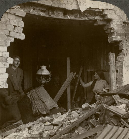 The damage done by a German Zeppelin bomb, World War I, 1914-1918.Artist: Realistic Travels Publishers