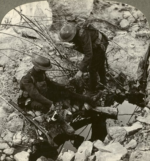 Giving water to a wounded pal, Hooge, Ypres, Belgium, World War I, 1914-1918.Artist: Realistic Travels Publishers