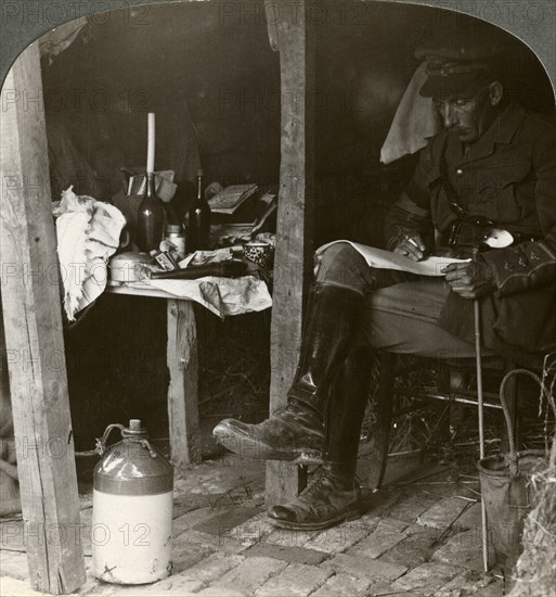 Staff officer in a dugout studying details before an offensive, World War I, 1914-1918Artist: Realistic Travels Publishers