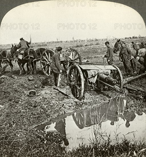 Removing a field gun from a flooded position, World War I, 1914-1918.Artist: Realistic Travels Publishers