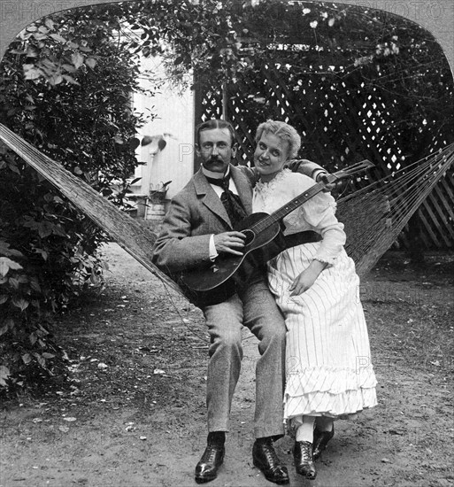 'The Musical Pair in the Hammock'.Artist: American Stereoscopic Company