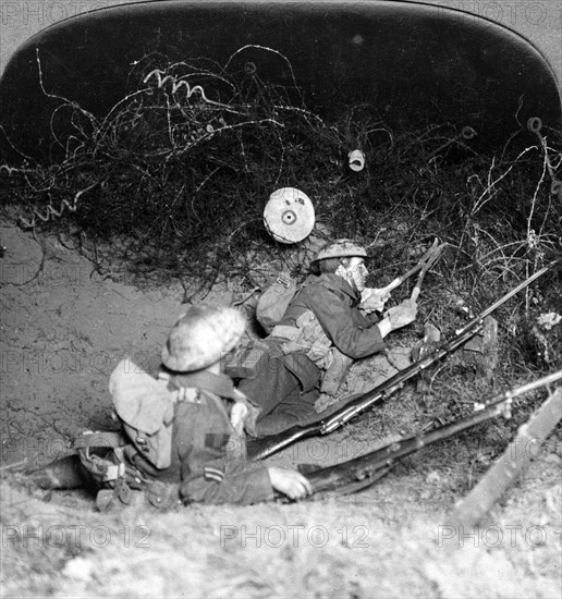 Soldiers cutting through barbed wire defences, Oppy, France, World War I, 1914-1918.Artist: Realistic Travels Publishers