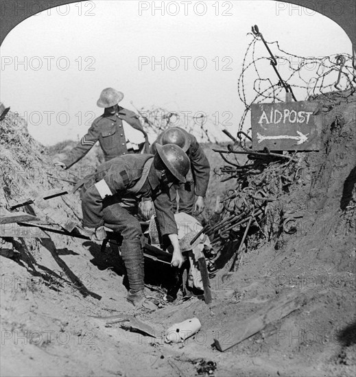Carrying a wounded soldier to a first aid post, Passchendaele, Belgium, World War I, 1914-1918.Artist: Realistic Travels Publishers