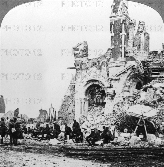 German prisoners of war beside the ruins of the basilica of Albert, France, World War I, 1914-1918.Artist: Realistic Travels Publishers