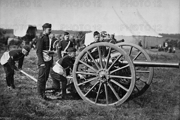 Gunners of field artillery drilling with a 12 pounder, 1895. Artist: Gregory & Co