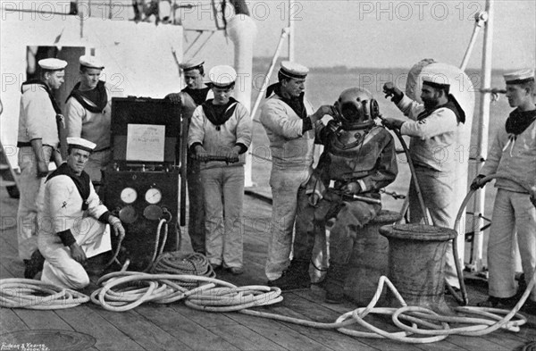 Diver and his apparatus on board HMS 'Blake', 1896. Artist: Gregory & Co