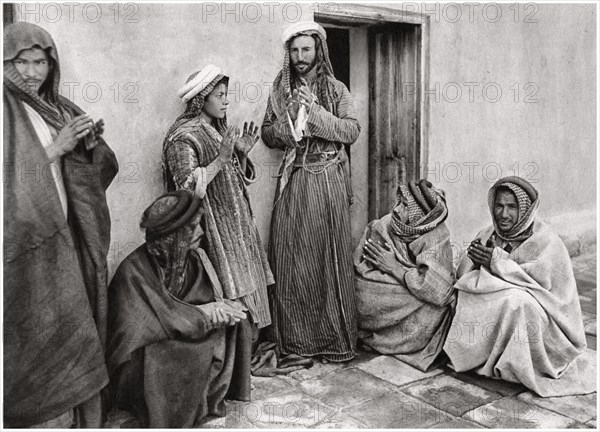 A mullah teaching a prayer to a young man, Iraq, 1925.Artist: A Kerim