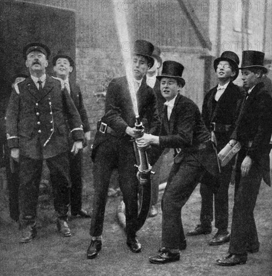 Eton's amateur firemen practising a hose drill, Berkshire, c1922. Artist: Unknown