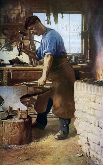 Blacksmith at work, England, c1922. Artist: Sidney H Nicholls