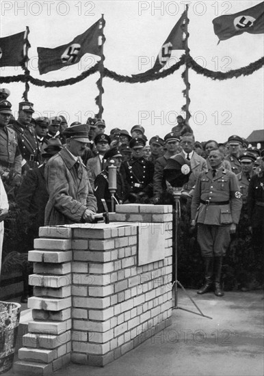The Führer puts the foundation wall to the meeting house in the Adolf-Hitler-Koog. Artist: Unknown