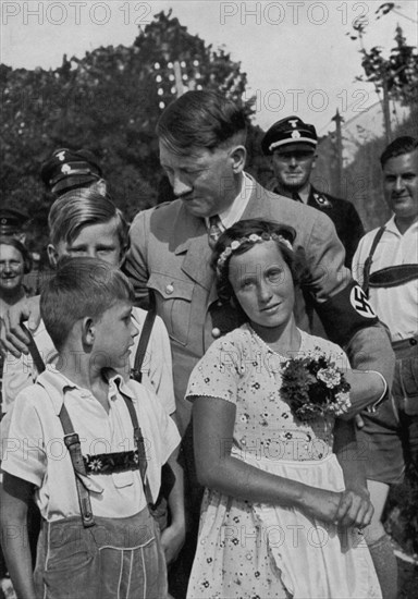 Adolf Hitler with a group of young children, 1936. Artist: Unknown